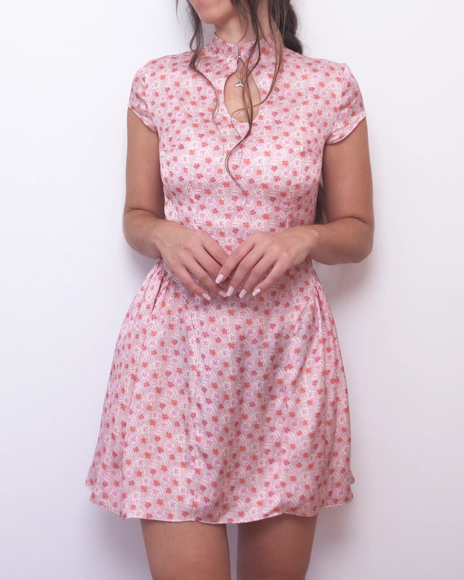 Front view of the pink floral Ayris mini dress with a Mandarin collar, keyhole neckline and short sleeves.