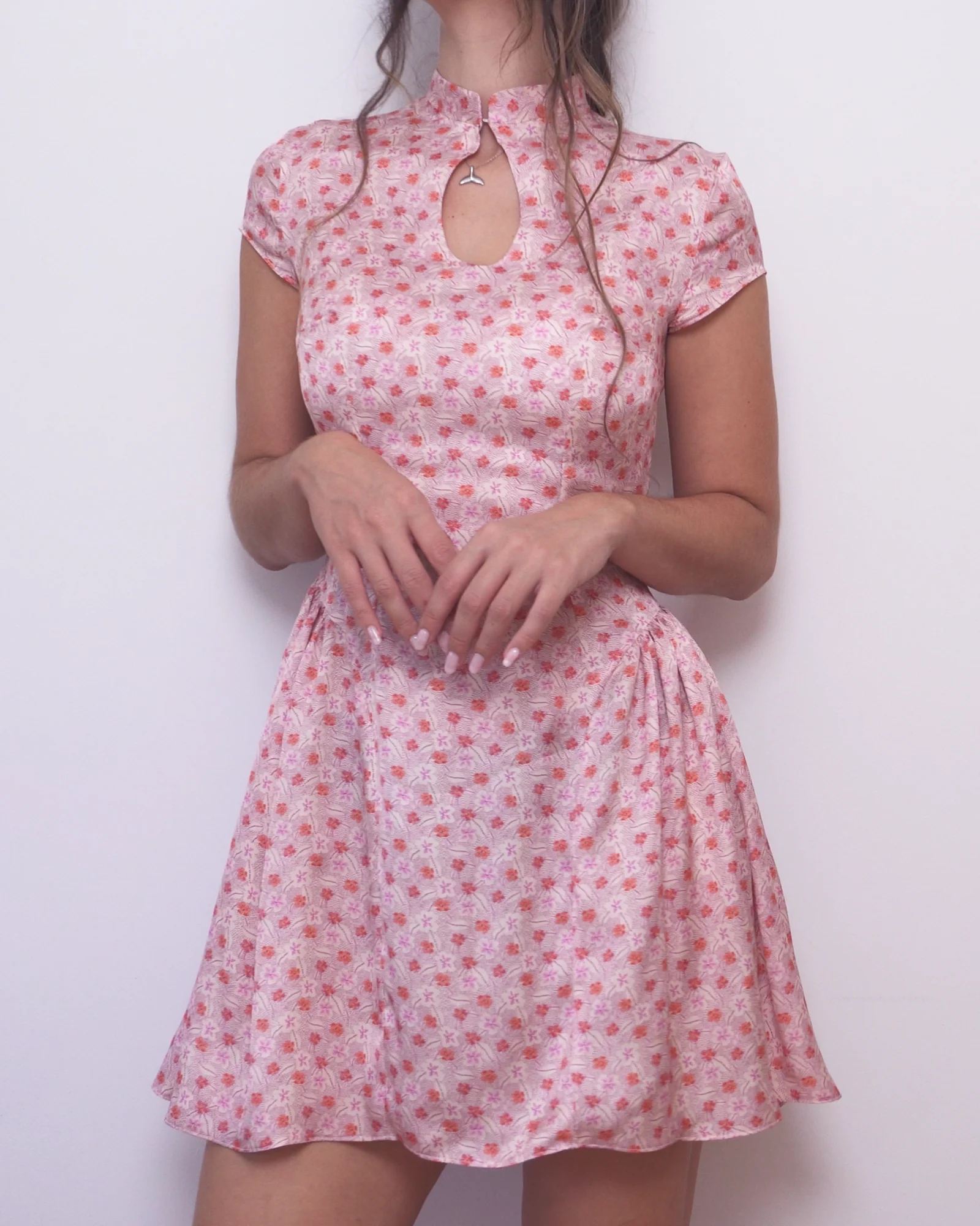 Pink floral Ayris dress showing the fitted bodice, keyhole neckline and gathered skirt at the waist.